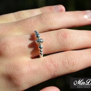 Handmade sterling silver bead stretch ring.
