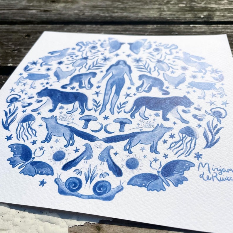 May include: A blue and white watercolor illustration of a circle with various animals, plants, and celestial objects. The illustration includes a woman, foxes, butterflies, mushrooms, snails, stars, and a crescent moon. The artist's name, "Mirjam de Ruwe", is written in the bottom right corner.