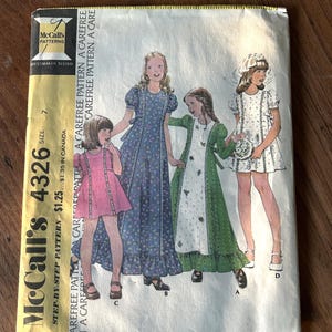 May include: Vintage McCall's 4326 sewing pattern for children's and girls' dresses. The pattern envelope features illustrations of four different dress designs. The envelope is yellow and white with the McCall's logo and pattern number.