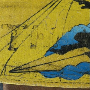 May include: Close-up of a yellow, textured surface with a vintage illustration. The artwork features black lines radiating from the top and blue cloud-like shapes. The piece has a distressed appearance, suggesting age and wear.