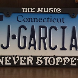 Grateful Dead License Plate Frame; The Music Never Stopped / Jerry Garcia / Dead & Company