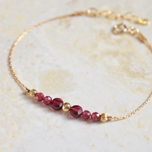 GARNET - Minimalist bracelet with a very thin gold filled chain and garnet and 14 carat gold filled beads.