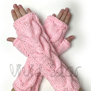 May include: A pair of pink knitted fingerless gloves with a cable knit pattern.