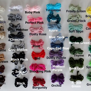 May include: A chart of yarn colors with names for each color. The colors include ivory, white, baby pink, turquoise, frosty green, bright yellow, coral, carrot, red, dusty purple, shocking pink, burgundy, teal, azure, blue fleck, green fleck, soft sage, hunter green, thyme, paddy green, medium purple, dark leaf, spring green, forest green, and green tones.