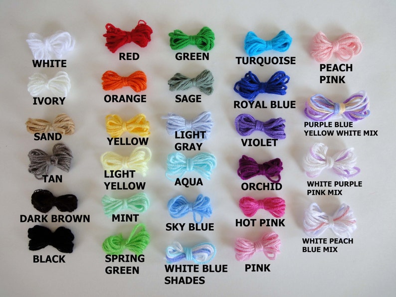 May include: A chart of yarn colors with the names of each color written below the yarn. The colors include white, ivory, sand, tan, dark brown, black, red, orange, yellow, light yellow, mint, spring green, green, sage, aqua, sky blue, turquoise, royal blue, violet, orchid, hot pink, peach pink, purple blue yellow white mix, white purple pink mix, and white peach blue mix.
