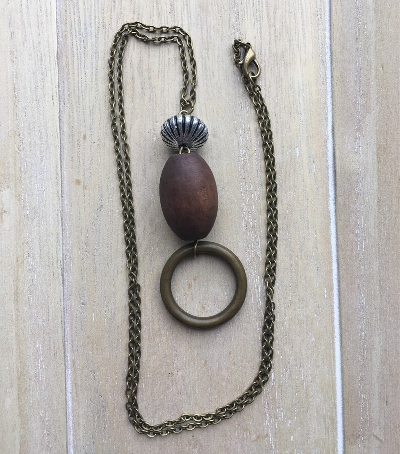 Long brown bronze colored necklace with beaded pendant.