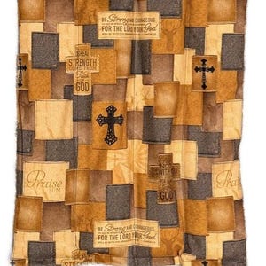 May include: A patchwork quilt in shades of brown, tan, and gray, featuring rectangular and square patches. The quilt has several crosses and text that reads "Be Strong and Courageous", "Great Strength Comes From Faith", and "Praise Him".