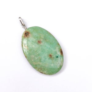 May include: A green oval pendant with brown flecks, made of a natural stone, with a silver bail.