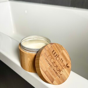 K&ouml;nnte beinhalten: Ein wei&szlig;es, h&ouml;lzernes Gef&auml;&szlig; mit Deckel. Das Gef&auml;&szlig; ist mit "white rabbit natural skincare" beschriftet.