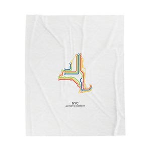 May include: White blanket featuring a colorful graphic of the New York City subway map in the shape of the state. The map uses red, yellow, green, and blue lines. The text "NYC" and coordinates are below the map.