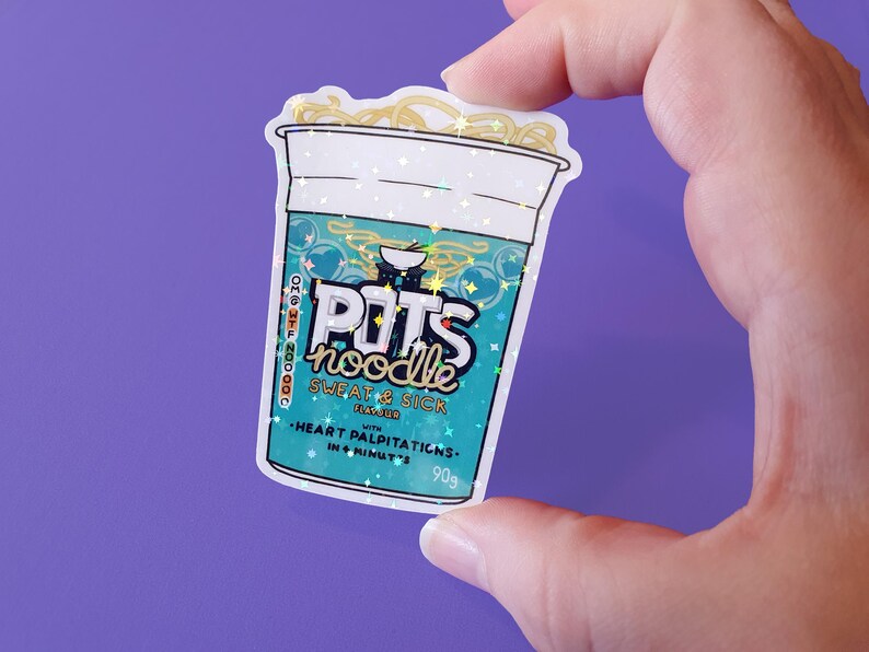 May include: A sticker of a blue and white instant noodle cup with the text "POTS noodle SWEAT & SICK" and "HEART PALPITATIONS. IN 4 MINUTES. 90g". The sticker has a glittery finish.