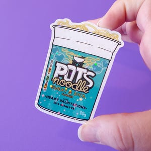 May include: A white sticker with a blue and green design of a cup of instant noodles. The sticker has the text "POTS noodle SWEAT & SICK" and "HEART PALPITATIONS - IN 4 MINUTES - 90g".