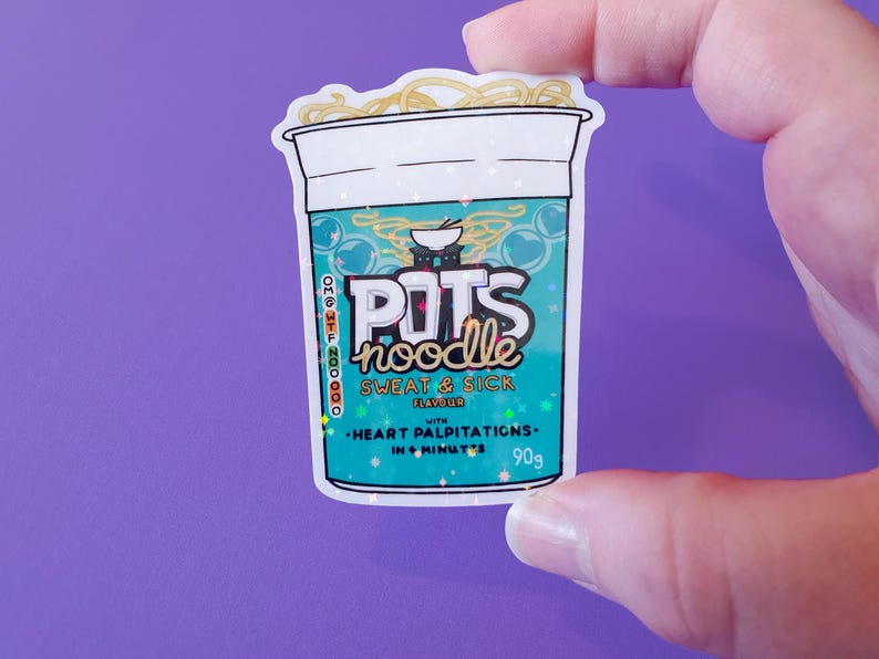 May include: A sticker of a blue and green instant noodle cup with the text "POTS noodle" and "SWEAT & SICK FLAVOUR" with a small bowl of noodles on top. The sticker has a glittery finish and the text "HEART PALPITATIONS - IN 6 MINUTES - 90g" is printed on the bottom.