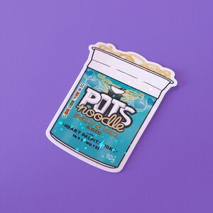 May include: A sticker of a blue and white instant noodle cup with the text "POTS noodle SWEAT & SICK FLAVOUR with HEART PALPITATIONS in 4 MINUTES 90g" printed on it.
