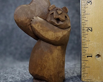 This artist carved wood bear is collectible, made in America; a miniature gift with original design, carved by hand, it makes a happy gift.