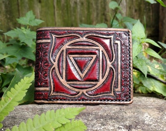 Handmade leather bifold wallet tooled with yogic root chakra emblem