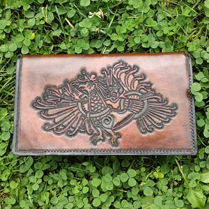 Travel notebook cover with four strings and engraved with a Nordic bird
