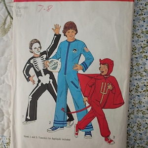 May include: Vintage Simplicity sewing pattern 6696 featuring illustrations of three children in Halloween costumes: a skeleton, an astronaut, and a devil. The pattern is for sizes 7-8, with the Simplicity logo and price visible.