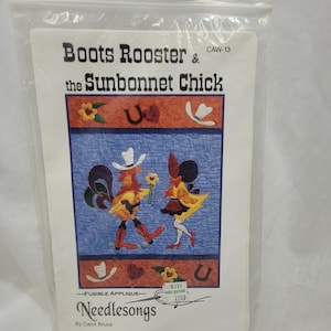 May include: A clear plastic bag containing a fusible applique pattern titled Boots Rooster & the Sunbonnet Chick by Needlesongs. The pattern features a rooster and a chick in western attire on a blue quilted background with decorative borders.