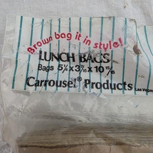 May include: A package of lunch bags with the text "Brown bag it in style!" and "LUNCH BAGS". The bags are 5 1/4 x 3 3/16 x 10 15/16 inches. The brand name "Carrousel Products" is also visible.