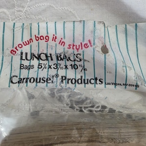 May include: A package of lunch bags with the text "Brown bag it in style!" and "LUNCH BAGS". The bags are 5 5/8 x 3 3/16 x 10 15/16 inches. The packaging has a blue and white striped design and the brand name "Carrousel Products".
