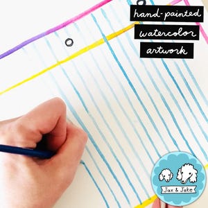 May include: Hand-painted watercolor artwork with blue vertical lines on white paper. The artwork includes the text "hand-painted watercolor artwork". A hand is holding a blue pencil, adding to the artwork. The Jax & Jake logo is in the bottom right corner.