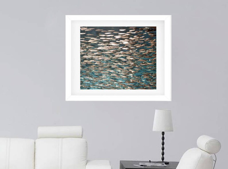 May include: A framed abstract art print featuring a teal and gold color scheme. The print depicts a swirling pattern of overlapping shapes, resembling water or fish scales.