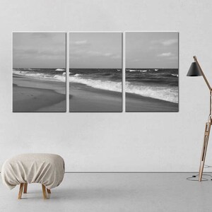 May include: A black and white photograph of ocean waves crashing on a sandy beach. The photo is split into three panels.