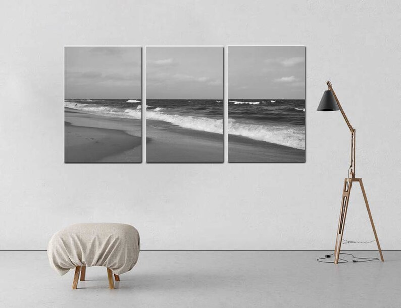 May include: A black and white photograph of ocean waves crashing on a sandy beach. The photo is split into three panels.