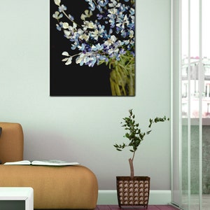 May include: A bouquet of blue and white flowers with green stems against a black background.