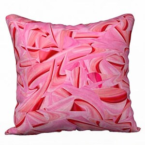May include: Pink and red abstract pattern throw pillow. The pillow is made of a soft, comfortable fabric and features a unique, modern design.