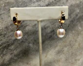 14k gold fill Huggie hoop pierced earrings with oval freshwater pearls.