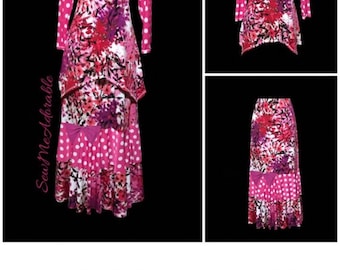 May include: A pink and white patterned dress with a long sleeve top and a skirt with a bow. The dress has a layered design with a white polka dot pattern on the bottom layer. The text "Sew Measurable" is visible on the left side of the image.