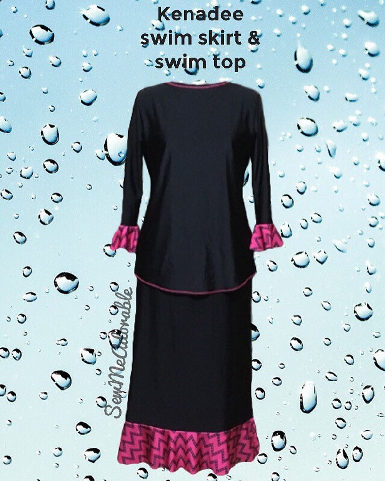 May include: A black Kenadee swim skirt and swim top set featuring long sleeves with pink and black chevron patterned ruffled cuffs and a matching ruffled hem on the skirt. The top has a pink neckline trim and the text Kenadee swim skirt & swim top.