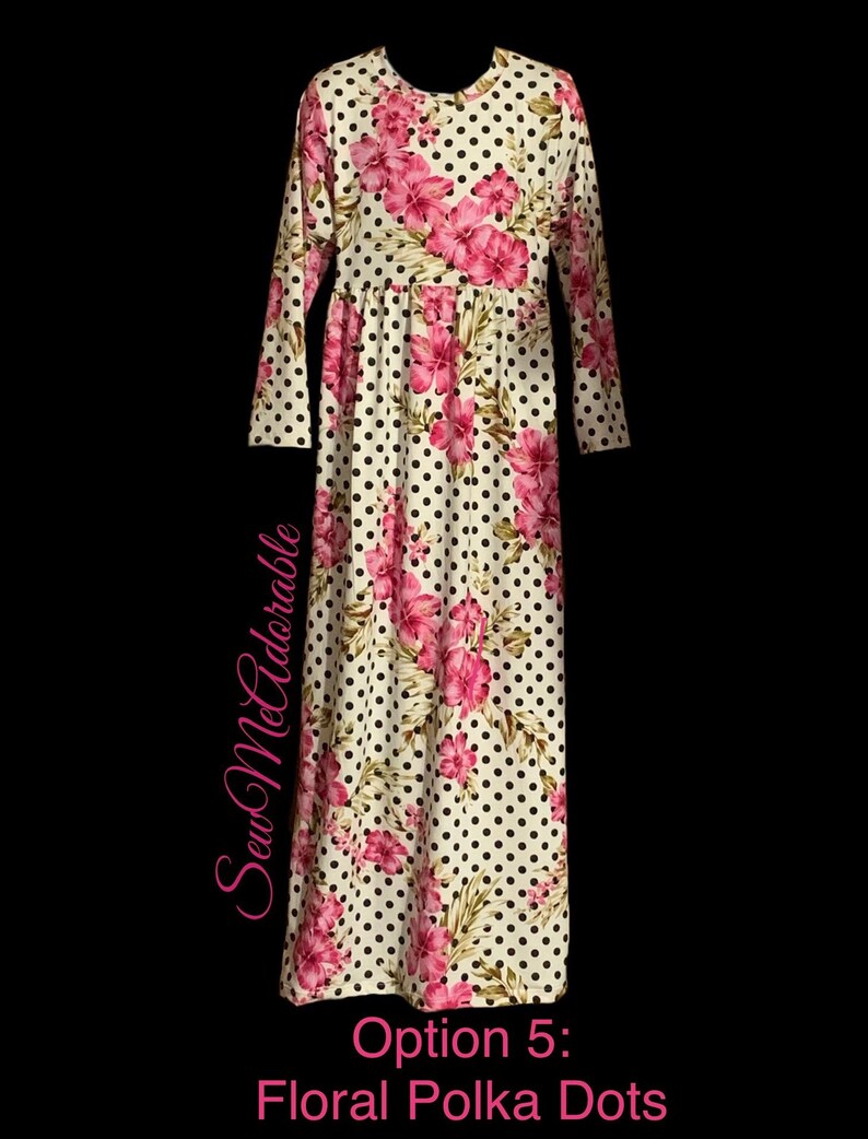 May include: A white long-sleeved dress with a floral and polka dot pattern. The dress has a pink floral print on a white background with black polka dots. The dress has a gathered waist and long sleeves.