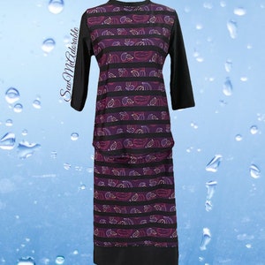 May include: A long-sleeved tunic and skirt set featuring a black and purple striped pattern with small white and red leaf motifs. The garment includes solid black sleeves and a solid black hem. The text SewMeAdorable is printed on the left side.