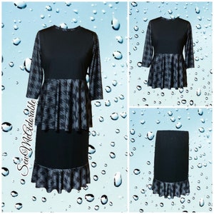 May include: A two-piece outfit consisting of a black top with three-quarter sleeves and a peplum hem featuring a grey and black houndstooth pattern, paired with a matching black skirt with a houndstooth ruffled hem. The text SewMcAdorable is visible.