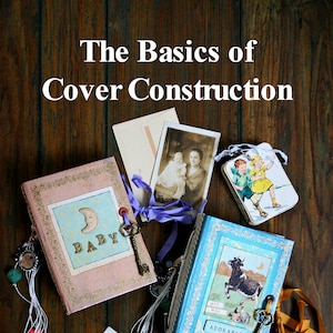 May include: Two handmade journals with decorative covers. The pink journal has a blue and white moon and stars design with the word "BABY" in gold letters. The blue journal has a cow and a moon design with the words "MOO MOO" and "ADORABLE".