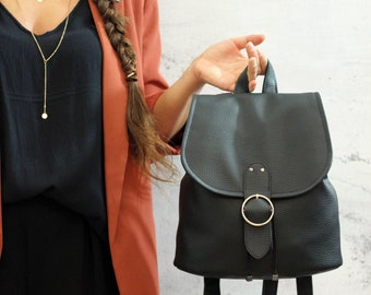 Black backpack with round gold closure. Vegan bucket backpack.