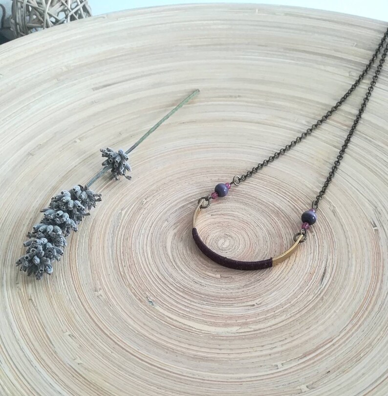 Long boho style necklace with dark bronze chain and gold half moon pendant decorated with grape silk thread round beads and glass beads