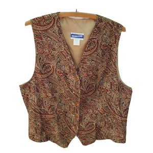 May include: A brown, gold, and black paisley patterned vest with a button closure. The vest has a v-neck and is made by Pendleton.