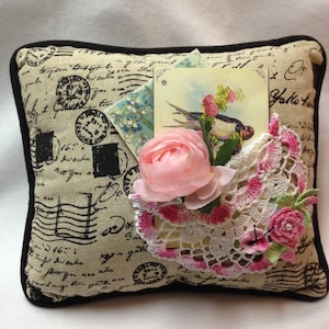 Burlap postcard pillow addorned with  pink and white hand crochet doillie pocket, crochet rose and a butterfly trimmed with black