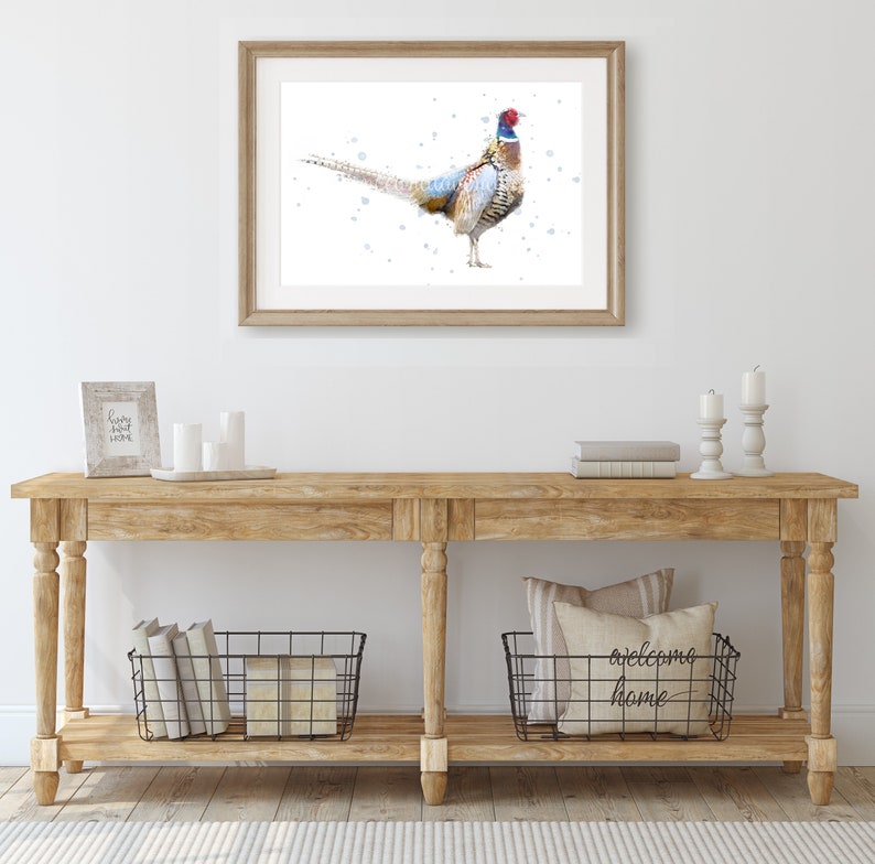 May include: A watercolor painting of a pheasant with a blue and red head and a brown, white, and gray body. The pheasant is standing on a white background with blue dots.