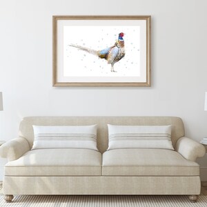May include: A watercolor painting of a pheasant with a blue and red head and a brown, white, and black body. The pheasant is standing on a white background with a few small dots of paint.