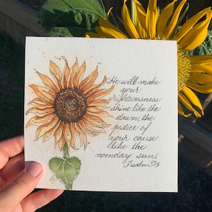 May include: Watercolor painting of a sunflower with a quote from Psalm 37:5, "He will make your righteousness shine like the dawn, the justice of your cause like the noonday sun."