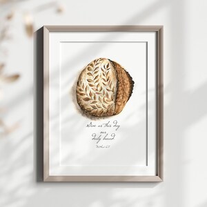May include: A watercolor painting of a loaf of bread with a leaf design. The text "Give us this day our daily bread. Matthew 6:11" is written below the bread.