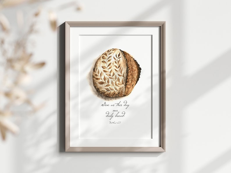 May include: A watercolor painting of a loaf of bread with a leaf design. The text "Give us this day our daily bread. Matthew 6:11" is written below the bread.