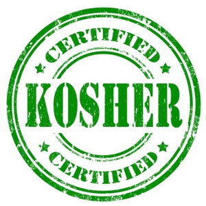 May include: A green, circular stamp with the words "CERTIFIED" and "KOSHER" in bold, distressed font. The stamp has a grunge effect, with star accents and a textured appearance, indicating certification.