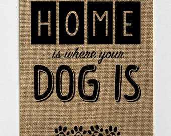 May include: A burlap print with black text that reads "HOME is where your DOG IS" with four black paw prints at the bottom.