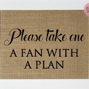 May include: A burlap sign with the text "Please take one a fan with a plan" in black lettering.